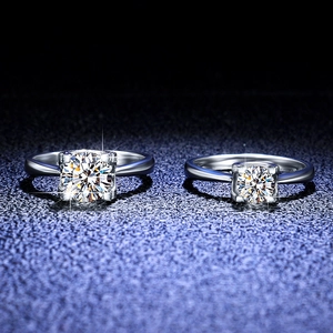 Macro detail of two S925 sterling silver moissanite rings with classic four-prong settings