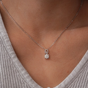 Elegant S925 sterling silver necklace featuring a 1-carat moissanite pendant on a model