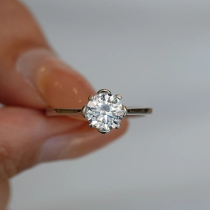 925 sterling silver ring with a brilliant round cut moissanite in six-prong floral setting