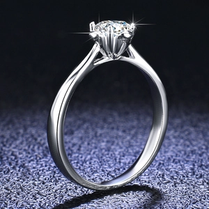 Macro detail of classic six-prong setting with a brilliant round-cut moissanite stone