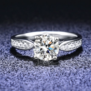 Macro view of 1 carat moissanite ring with four-prong setting and pavé side stones
