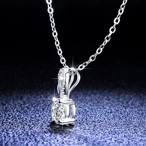 Macro detail of a 1 carat round moissanite pendant set in 925 sterling silver with sparkles