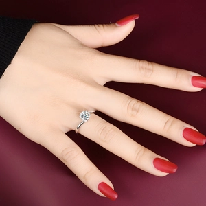 Macro view of S925 silver moissanite ring with a bypass shank on a model's finger
