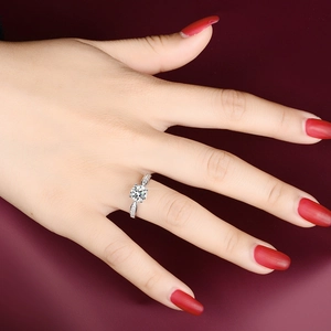 Detailed view of s925 silver six-prong moissanite ring with side accent diamonds on hand