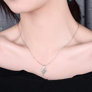 Detailed view of an s925 silver necklace with a 0.5 carat moissanite on a model