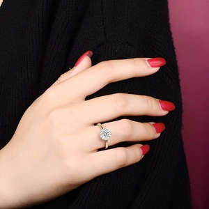 Close-up of 1 carat moissanite ring with halo setting on a model finger