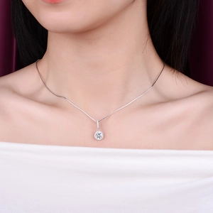 Classic silver necklace with a 1ct round moissanite pendant worn by a model