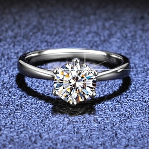 Macro detail of classic six-prong solitaire ring with a sparkling round-cut stone