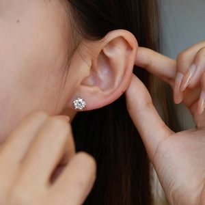Elegant S925 silver snowflake stud earrings with sparkling moissanite on a model