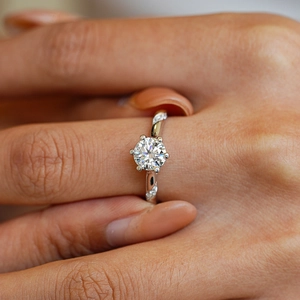 S925 sterling silver six-prong moissanite ring with twisted pavé band on a model hand