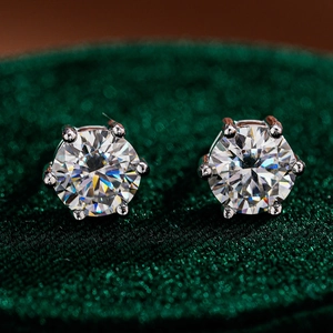 Macro shot of 925 sterling silver six-prong moissanite stud earrings on velvet