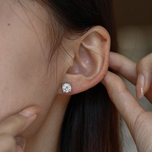 Classic round moissanite stud earring in S925 sterling silver worn by female model