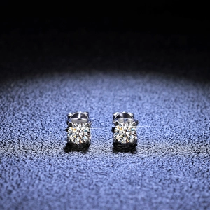 Macro detail of silver moissanite stud earrings featuring classic four-prong setting
