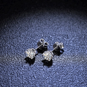Close-up of S925 silver snowflake earrings with round-cut moissanite in four-prong setting