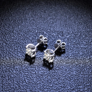 Close-up of S925 silver moissanite stud earrings with classic four-prong setting