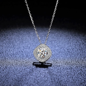 Detail of s925 silver necklace with a 1-carat square halo moissanite pendant on blue background