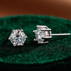 Elegant six-prong S925 silver stud earrings with moissanite on green velvet