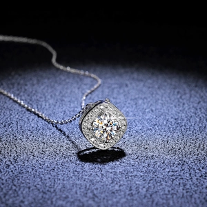 Macro shot of s925 silver necklace featuring a cushion-cut double halo pendant with moissanite