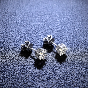 Macro shot of S925 sterling silver moissanite stud earrings in four-prong setting