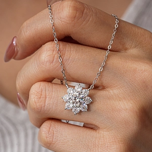 925 sterling silver sunflower moissanite necklace held to show brilliant diamond shine