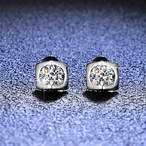 Macro detail of heart-shaped moissanite earrings in square 925 silver setting