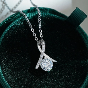 S925 sterling silver moissanite necklace with ribbon pendant on green velvet box