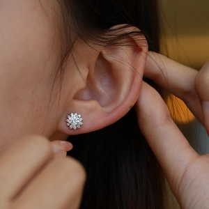 Elegant S925 silver sunflower stud earrings with sparkling moissanite on model ear