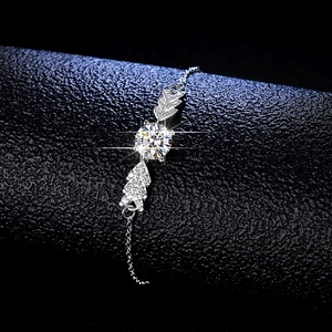 Elegant 925 sterling silver angel wing bracelet featuring a round moissanite center stone