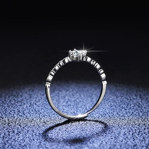 Single moissanite silver ring featuring a sparkling round diamond and a unique wavy band
