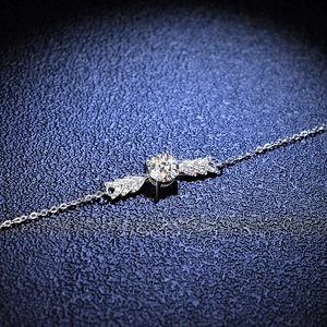 Elegant 925 sterling silver angel wing bracelet featuring a brilliant moissanite stone