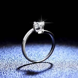 Classic round moissanite ring in 925 sterling silver with four-prong setting and side diamonds
