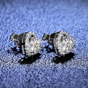 Macro shot of heart-shaped S925 silver stud earrings with moissanite pave setting