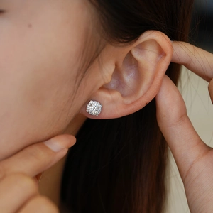 Elegant S925 silver moissanite stud earrings featuring a classic halo design on model