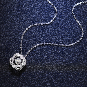 S925 sterling silver necklace with sparkling moissanite pendant on textured blue leather
