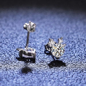 Macro shot of S925 silver reindeer antler earrings with sparkling moissanite main stone