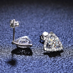 Macro shot of S925 silver triangle moissanite studs with halo pavé and brilliant fire