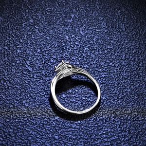 Classic 0.5ct moissanite silver ring featuring a four-prong setting on a blue surface