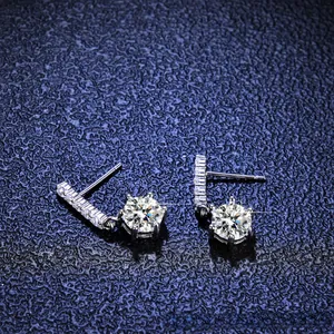Detailed view of silver drop earrings featuring brilliant moissanite stones and pave accents