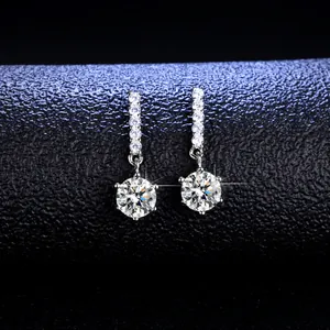 Macro shot of S925 silver earrings with brilliant cut moissanite on black leather