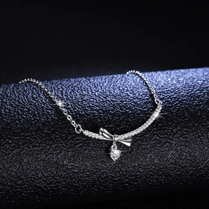 Elegant S925 sterling silver bow necklace featuring a heart-cut moissanite pendant