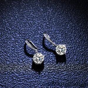 Macro shot of 925 silver moissanite drop earrings with round brilliant-cut stones