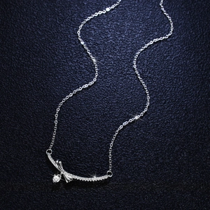 S925 silver bow pendant necklace with 0.1ct moissanite stones on dark textured leather