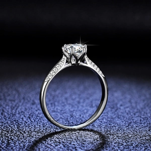 Classic six-prong moissanite ring in sterling silver with side stones and star effect