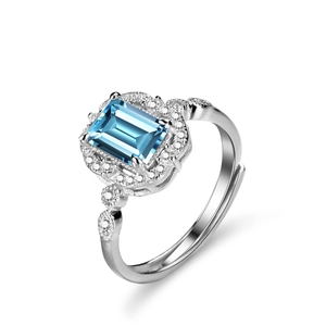Elegant emerald cut blue topaz ring in sterling silver with side stones and adjustable band