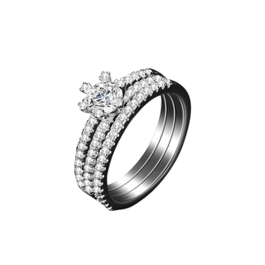 Macro detail of 925 silver triple row ring set featuring classic six-prong moissanite