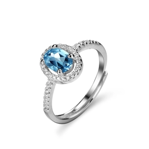 Bague ajustable en argent avec topaze bleue ovale et pavage de pierres halo