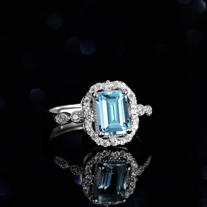 Emerald cut blue topaz sterling silver ring with pavé diamonds and vintage marquise details