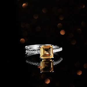 Blue Topaz Princess Cut Sterling Silver Ring with Moissanite Accents on Black Background