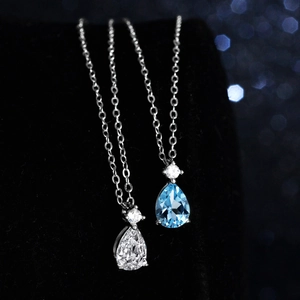 Pear cut natural blue topaz and moissanite teardrop pendant necklace in 925 sterling silver