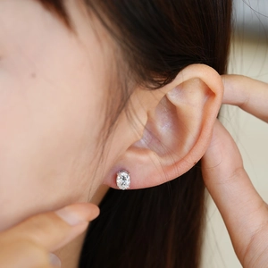 Elegant s925 silver oval-cut moissanite stud earrings with a four-prong setting on ear